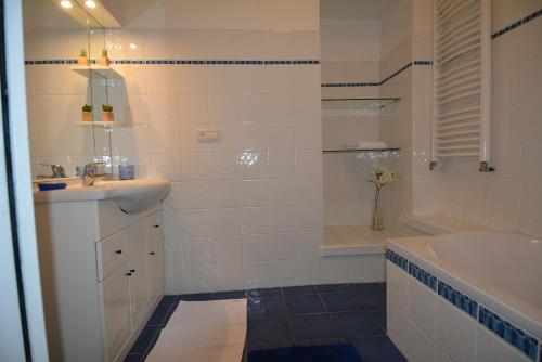 a bathroom with a sink and a shower and a tub at Appartement Saint-Malo Intra Muros in Saint Malo