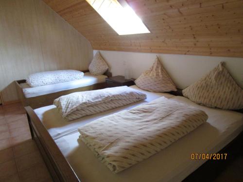 a room with two beds with pillows on them at Ferienwohnung Hück in Lind