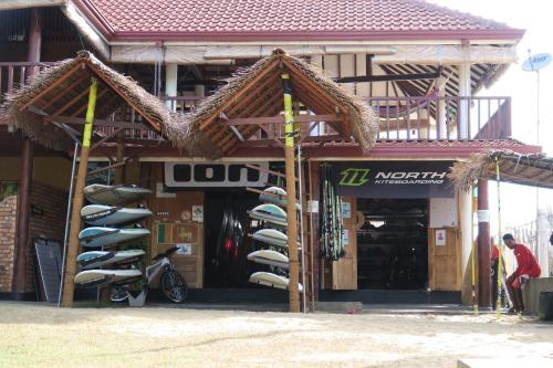 a surf shop with a rack of surfboards at De Silva Palm Resort in Kalpitiya