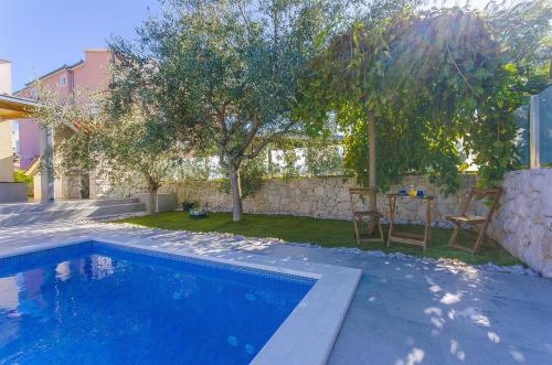 uma piscina num quintal com uma mesa e árvores em Villa Vesa em Sevid