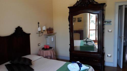 a bedroom with a large mirror and a bed at B&B Casa Laviano in Melfi