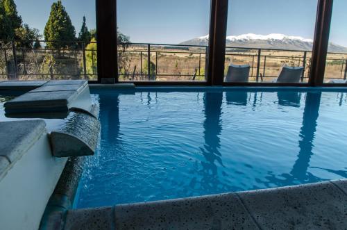 a swimming pool with a view of the mountains at Arroyo Escondido in Trevelin