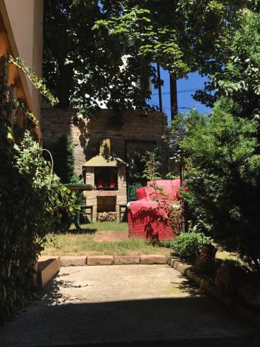 a garden with a red table and a building at Apartment Centar in Sarajevo
