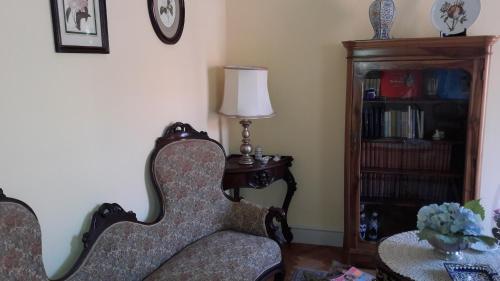 a living room with a chair and a table with a lamp at B&B Casa Laviano in Melfi