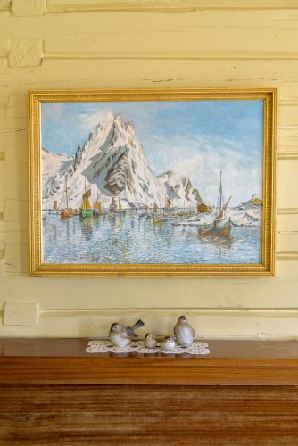 a painting on a wall with boats in the water at Kabelvåg Feriehus & Camping in Kabelvåg