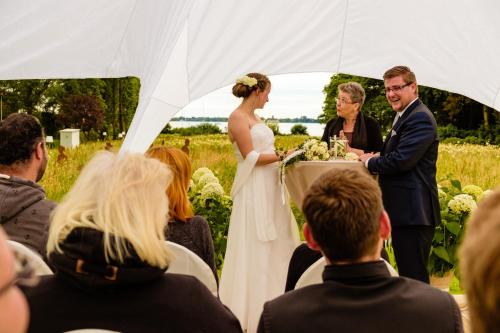a bride and groom exchange vows at their wedding ceremony at Das 53°Hotel in Bad Zwischenahn