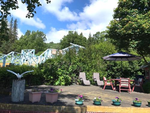 a patio with a table and chairs and a roller coaster at Halcyon Heights B&B/Inn in Homer