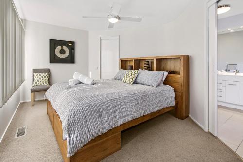 a bedroom with a bed with a wooden headboard at Cloud Nine in Rye
