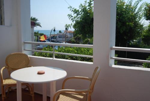 a room with a table and chairs and a window at Hotel El Puntazo I in Mojácar