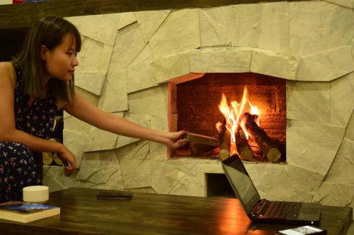 a woman standing in front of a brick oven at Phuong Nam Hotel in Sa Pa