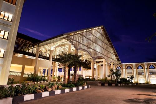 a building with a lit up facade at night at Radisson Blu Resort, Goa in Cavelossim