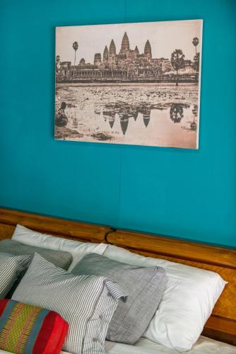 a bedroom with a bed with a picture on the wall at Oasis Yoga Bungalows in Ko Lanta