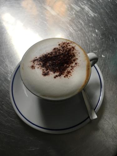 a cup of coffee sitting on a table at B&B Villa Pardi Lucca in Lucca