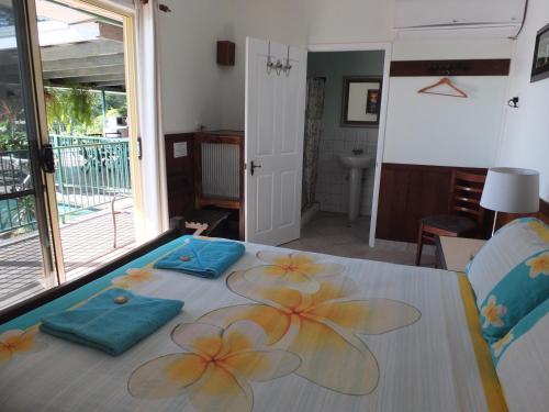 a table with flowers on it in a living room at Daintree Riverview Lodges in Daintree