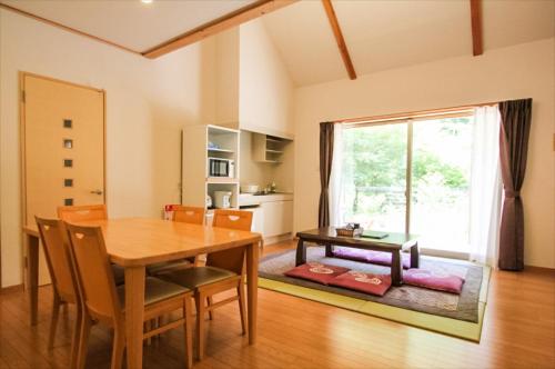 a dining room with a table and a window at Yadori Onsen Iyashinoyu in Hashimoto