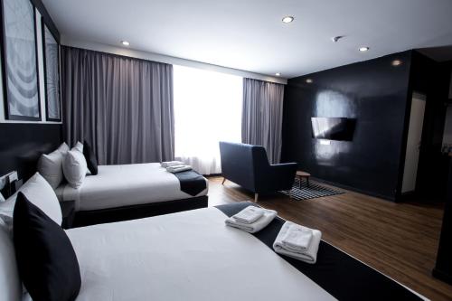 Postel nebo postele na pokoji v ubytování Bloommaze Boutique Hotel Puchong