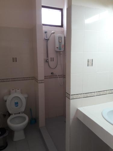 a bathroom with a shower and a toilet and a sink at Southern Fried Rice in Kata Beach