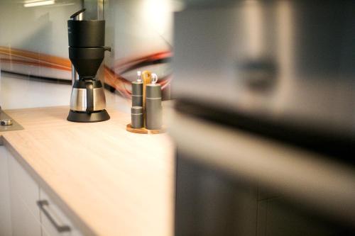 a counter with a coffee maker and candles on it at Am Schmeding in Berlin