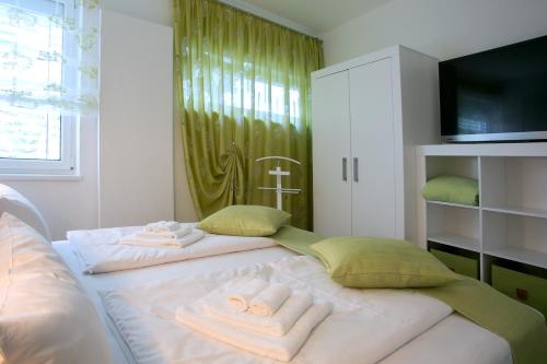 a bedroom with a bed with towels on it at Am Schmeding in Berlin