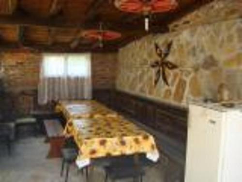a room with a bed and a table in it at Morski Rai Rooms in Byala