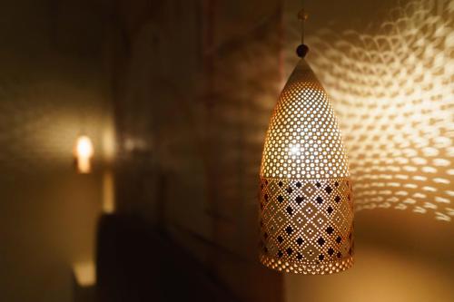 a lamp hanging from a wall in a room at Antica Torre di Iuso in Matera