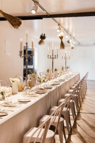 a long table in a room with chairs and candles at Cradle Boutique Hotel in Lanseria