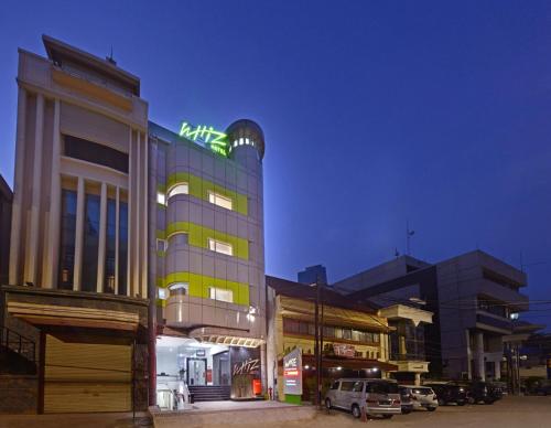 a building with a green sign on top of it at Whiz Hotel Falatehan Jakarta in Jakarta