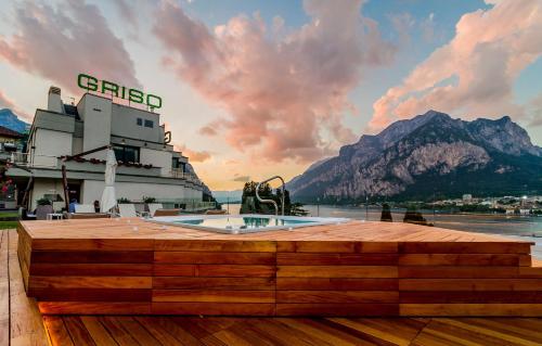 a view of a cruise ship with mountains in the background at Hotel Griso Collection in Malgrate