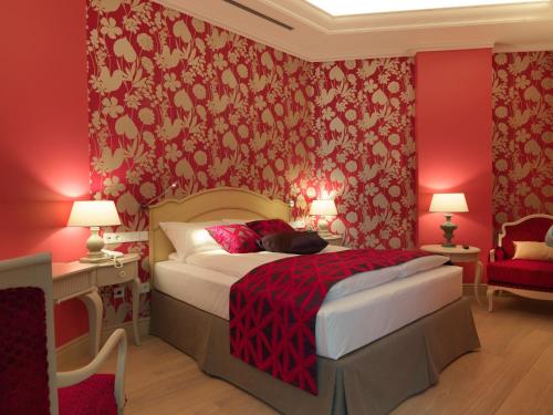 a bedroom with red walls and a bed with a red bedspread at Relais Le Chevalier in Rīga