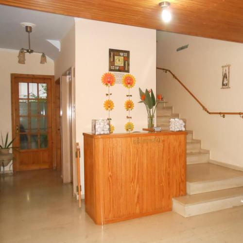 a room with stairs and flowers on the wall at Studios Maria in Paralion astros