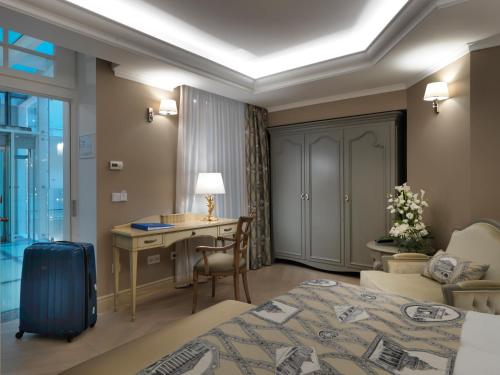 a hotel room with a bed and a desk at Relais Le Chevalier in Rīga