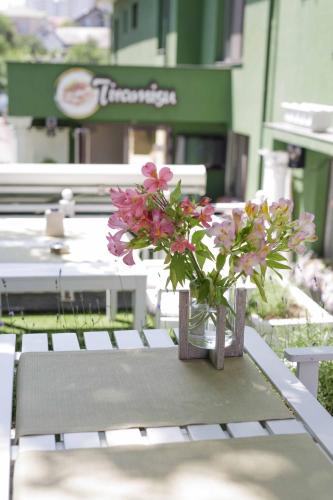 a vase of flowers sitting on top of a table at Weekend Boutique Hotel in Chişinău