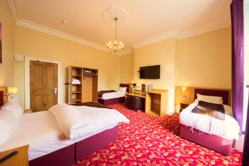 מיטה או מיטות בחדר ב-Edgerton Hotel