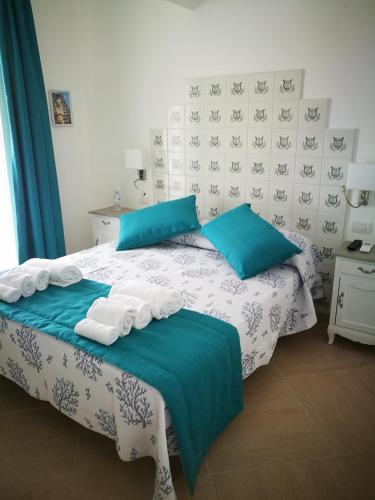 a bedroom with a bed with towels on it at Villa Patrizi in Capri