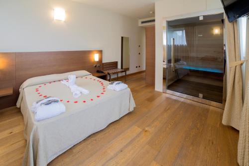 a bedroom with a bed with a bunny decoration on it at Hotel Lovere Resort & Spa in Lovere
