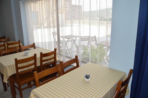a restaurant with tables and chairs and a large window at Imperio Hotel in Peso da Régua