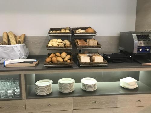 a bakery with bread and pastries on a counter at Hotel Gracia in El Arenal