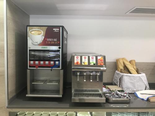 a coffee shop with a cup of coffee and bread at Hotel Gracia in El Arenal