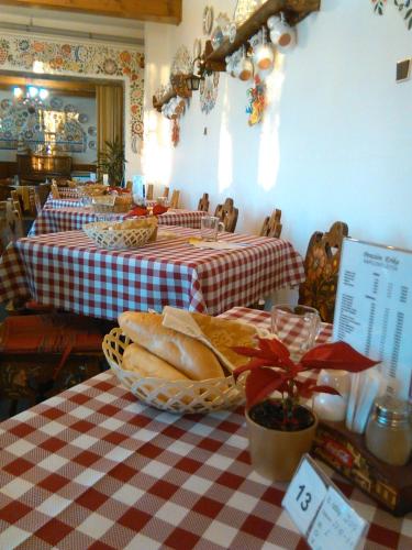 a restaurant with two tables with red and white checkered table cloth at Erika penzión in Vysoké Tatry
