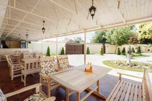 a patio with a wooden table and chairs at Asiya in Odesa