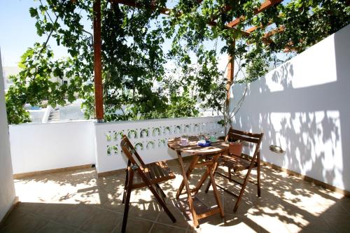 a table and two chairs on a patio at Anastasia Studios in Tinos Town