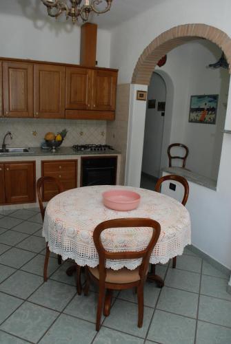 a kitchen with a table with a pink plate on it at Residence Villa Cristina in Ischia
