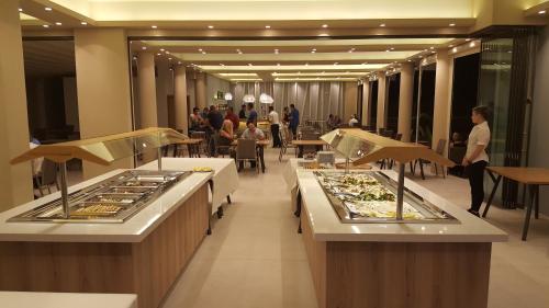 a buffet line with food on display in a restaurant at Selyria Resort in Tsilivi