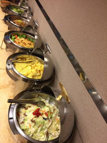 a row of plates of food on a buffet at Unique Hotel in Hualien City