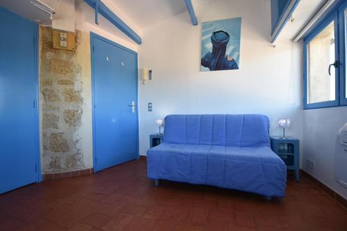 a blue couch in a room with a blue door at Le Provence Plage in La Seyne-sur-Mer