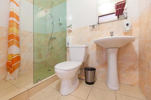 a bathroom with a toilet and a sink and a shower at Regina na Baumana in Kazan