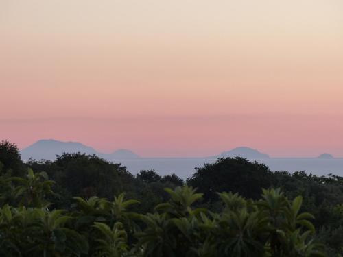 a sunset over the mountains in the distance at Gullo Capo Vaticano in Ricadi