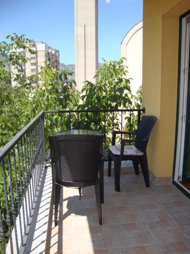 a balcony with two chairs and a table at Villa Salvia in Mostar