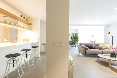 a living room and kitchen with a couch and a table at The Lucky Flats - Luceros in Alicante