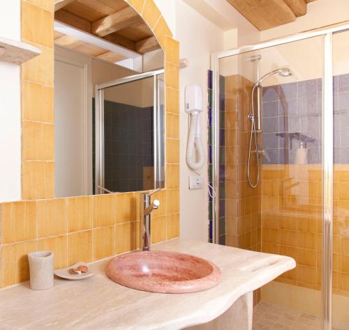 a bathroom with a sink and a shower at Via dei Mari Guest House in Oristano